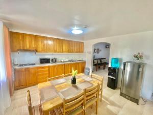 a kitchen with a wooden table and a dining room at Seashells Home in Panglao Island