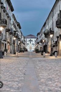 an empty street with a large building in the distance at Charlie's House in Venaria Reale