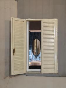 a mirror is seen through a window in a bathroom at Philosofia in Naples +115 photos