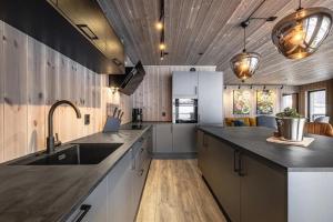 a kitchen with a sink and a counter top at Ski out ski in Luxus Hemsedal in Hemsedal