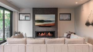 a living room with a couch and a fireplace at Triple 3 Lodge in Steamboat Springs