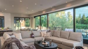 a living room with a couch and a large window at Triple 3 Lodge in Steamboat Springs