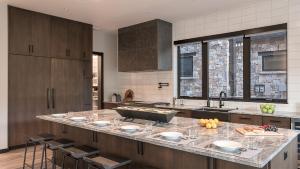a kitchen with a large counter with glasses on it at Triple 3 Lodge in Steamboat Springs