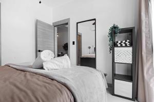 a bedroom with a bed and a large mirror at NOK Perfect 1 BR by Vistacana Rentals in Punta Cana