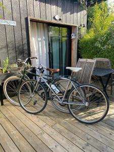 two bikes parked next to a bench on a deck at Beach House in Lège-Cap-Ferret
