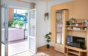 a living room with a tv and a sliding glass door at Apartment Nela in Brna