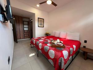 a bedroom with a red bed with a tray on it at Central Studio with Roof Top Romantic Zone 202 in Puerto Vallarta +57 photos