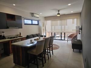a kitchen and living room with a table and chairs at Central Studio with Roof Top Romantic Zone 202 in Puerto Vallarta