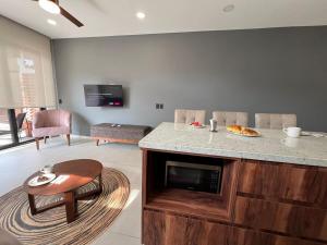 a living room with a kitchen with a counter top at Central Studio with Roof Top Romantic Zone 202 in Puerto Vallarta