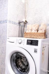 a washing machine with baskets on top of it at Downtown Rovaniemi, Perfect Location in Rovaniemi +5 photos
