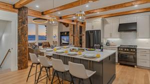a kitchen with a large island with white counter tops at Watchtower Chalet in Steamboat Springs +23 photos
