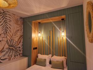 a bedroom with a bed with two pillows and a mirror at PASTORELLI DROITE - Appartement Nice 6P in Nice +7 photos