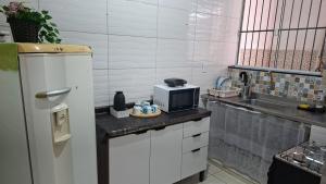 a kitchen with a counter with a microwave on it at Casa No Centro de Angra da Glaucia in Angra dos Reis +7 photos