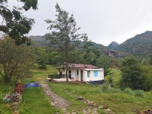 a small house in the middle of a field at Haven heights in Kanthalloor