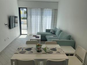a living room with a couch and a table and chairs at ازور in Aqaba