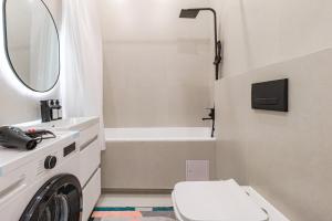a bathroom with a sink and a toilet and a tub at Жк Республика рядом с Хан Шатыр in Zhezdi +10 photos