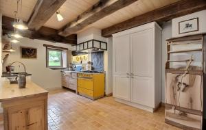 a kitchen with white cabinets and a yellow stove at Propriété De Campagne Typique in Brasparts +5 photos