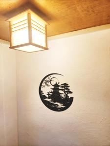 a wall with a chinese sign on it at D,A-House OSAKA in Osaka