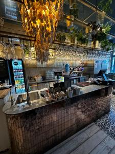 a bar in a restaurant with food on a counter at Oysters & Bubbles Gastro Rooms Rynek Square in Poznań