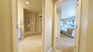 a hallway leading to a bedroom with a bed at River Ridge 423AB condo in Bend