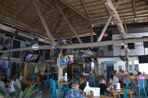 a group of people sitting at tables in a restaurant at Siesta Key Beach Resort and Suites in Sarasota