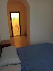 a bedroom with a bed and a door with a painting at Aeroporto Ciampino a soli 600 Mt Bici Grill Decimo Miglio in Ciampino