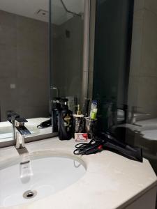 a bathroom counter with a sink and a mirror at Gulberg-Zameen Aurum starlit-Gym in Lahore