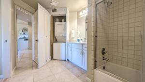 a bathroom with a shower and a sink and a tub at River Ridge 423A condo in Bend