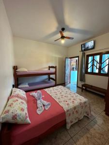 Ένα ή περισσότερα κρεβάτια σε δωμάτιο στο Pousada Solar de Anita Ferrugem