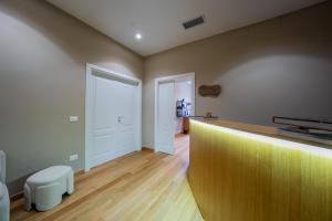 a room with a counter with a chair and a door at MAMA Relais in Rome