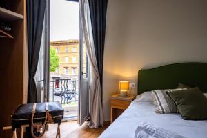 a bedroom with a bed and a large window at MAMA Relais in Rome