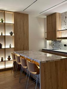 a kitchen with a counter with chairs around it at Vucko A 07 in Jahorina
