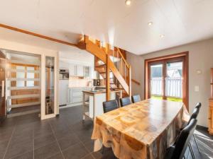 a kitchen and dining room with a wooden table and chairs at Nieuwendamme 108 in Nieuwpoort