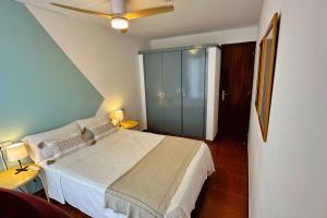 a bedroom with a bed and a ceiling fan at Nomad Haux Tossa de Mar 12 in Tossa de Mar