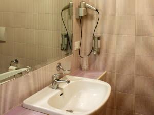 a white sink sitting under a mirror in a bathroom at Cà Del Moro Resort in Pontremoli