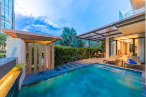 a swimming pool in the backyard of a house at Blue Sea villa in Cam Lâm