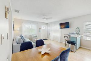 a living room with a table and chairs and a desk at Bay View Inn 202 in Bradenton Beach