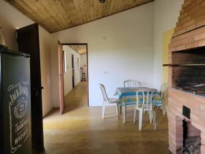 a kitchen and dining room with a table and chairs at EcoviLab in Guaratinguetá +15 photos