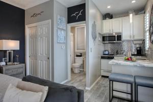a kitchen and living room with a couch and a table at Pacific Plaza #606 - Beach Birds - StudioD-K in Oceano