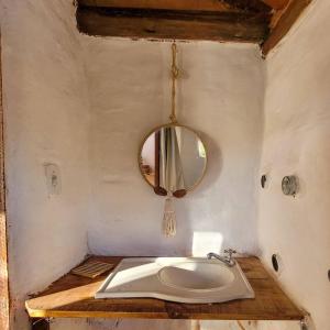 a bathroom with a sink and a mirror at EcoviLab in Guaratinguetá