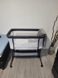 a metal bed frame in a bedroom next to a wall at Ferienhaus Eichen in Kreuztal
