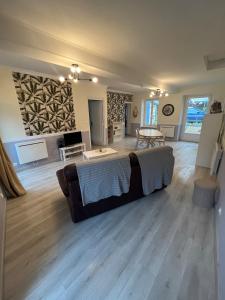 a large living room with a couch and a table at Appartement chaleureux aux portes de Navarrenx - Fibre in Susmiou