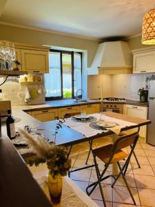 a kitchen with a table with chairs and a counter top at La casa di Eleonora in Roccabruna