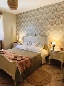 a bedroom with a large bed and two tables at La casa di Eleonora in Roccabruna
