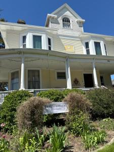 a white house with a sign in front of it at The Rest Is History in Baraboo