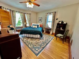 a bedroom with a bed and a ceiling fan at The Rest Is History in Baraboo