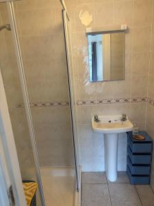 a bathroom with a shower and a sink at Central stunning sea view 2 bedroom apartment in Bundoran