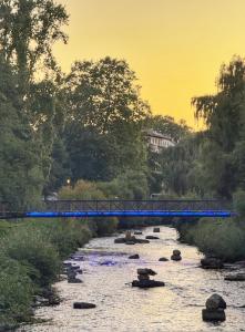 a blue bridge over a river with rocks at 3 Zimmer Apartment mit Sauna in Pforzheim