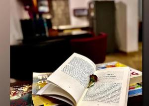 an open book sitting on top of a table at Sky Bloom Villa in Nagoa-Bardez