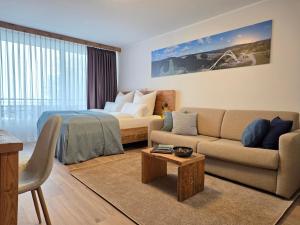 a living room with a couch and a bed at Ferienwohnung Fichtenzauber mit Balkon, nahe Bikepark & Skipiste in Winterberg +31 photos